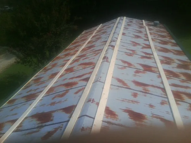 Rusted metal roof panels with new wood purlins before replacement — Storm Damage Roof Repair in Mexia by Roofing Brothers